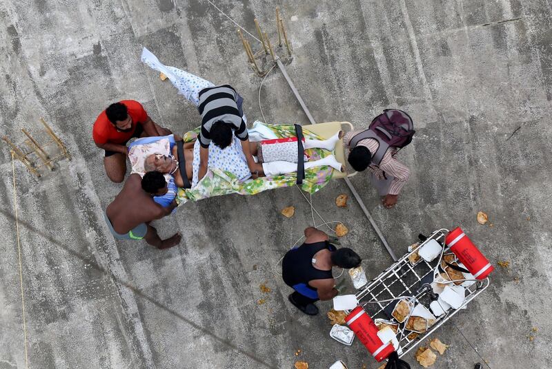 A sick man waits to be airlifted by the Indian Navy soldiers. Reuters