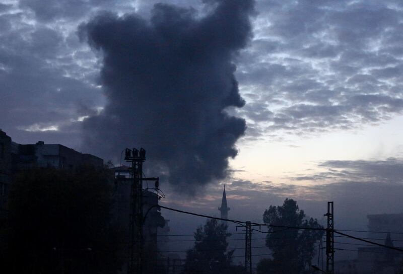 Smoke rises from buildings following bombardment on Kafr Batna, in the rebel-held Eastern Ghouta region on the outskirts of the Syrian capital on February 19, 208. Amer Almohibany / AFP
