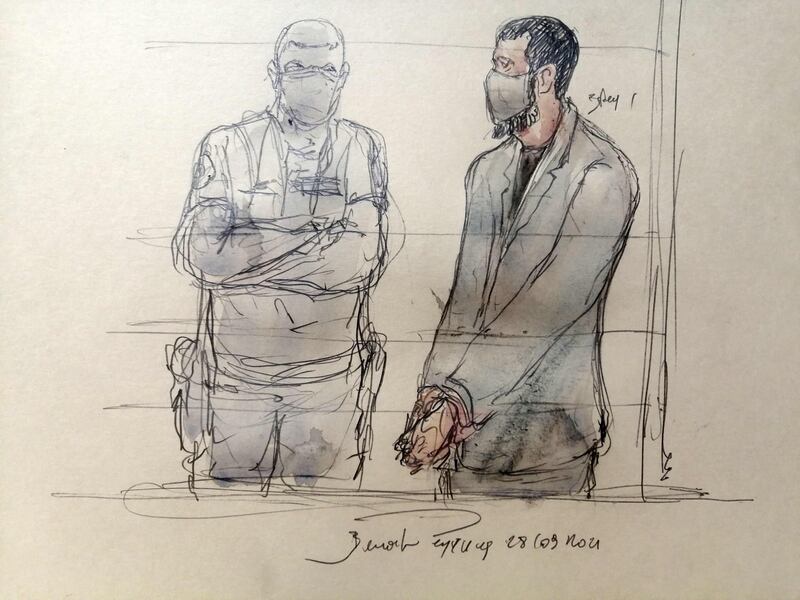 This court sketch shows Salah Abdeslam flanked by a policeman during the trial taking place at the Palais de Justice of Paris. AFP