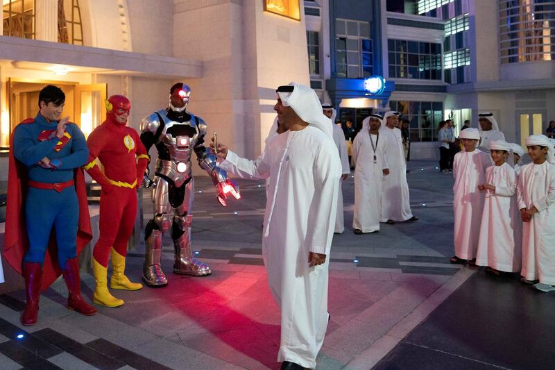 YAS ISLAND, ABU DHABI, UNITED ARAB EMIRATES - July 23, 2018: HHH Lt General Sheikh Saif bin Zayed Al Nahyan, UAE Deputy Prime Minister and Minister of Interior (C), takes a photo of super heroes during the opening of Warner Bros World Abu Dhabi. 

( Eissa Al Hammadi for The Crown Prince Court )
---