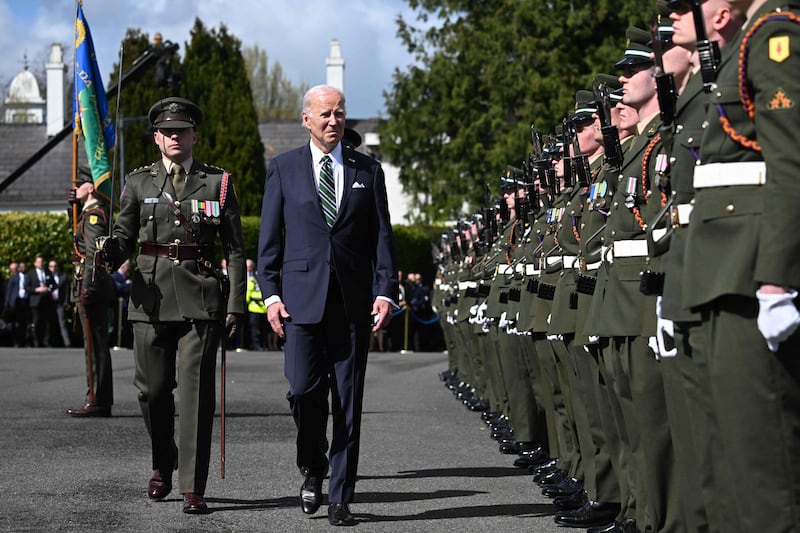 Mr Biden inspects the guard of honour at the Aras an Uachtarain in Dublin. AFP