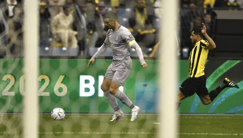 Al Nassr's Cristiano Ronaldo in action against Al Ittihad's Tarek Hamed. EPA