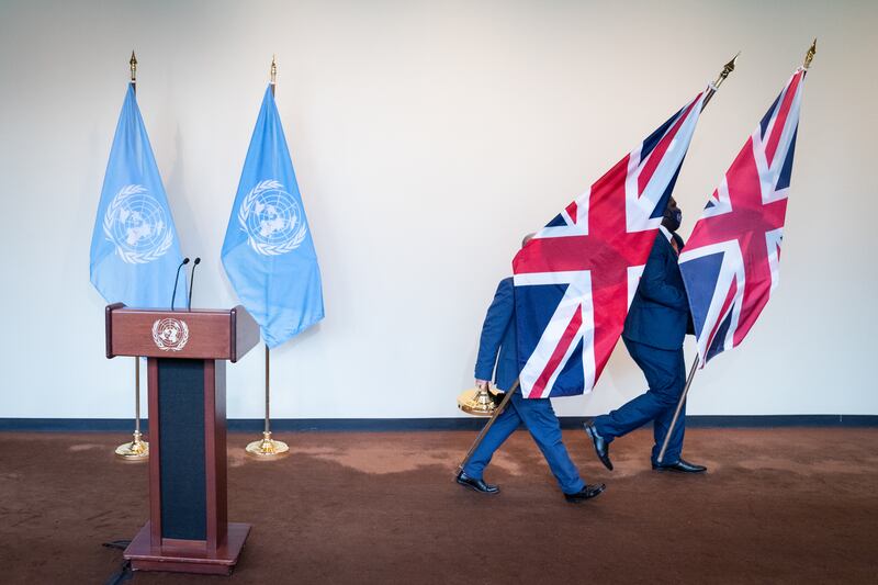 UN staff remove British flags from a podium after UK Prime Minister Boris Johnson addressed the media at the UN General Assembly. AP