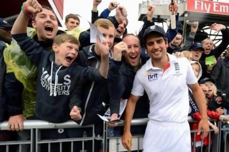 Alastair Cook celebrates retaining the Ashes with some England supporters.