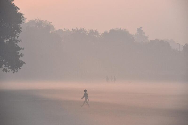 A young boy walks on a foggy day in New Delhi.  Chandan Khanna / AFP Photo