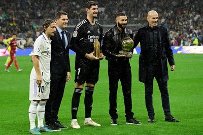 Luka Modric, Iker Casillas, Thibaut Courtois, holding the Yashin Trophy for best goalkeeper, Karim Benzema, holding the Ballon d'Or trophy, and Zinedine Zidane pose for a group picture. AFP