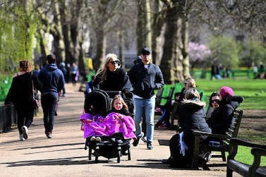 People walk through St James's Park in London as the UK begin its first phase of easing lockdown restrictions. EPA.