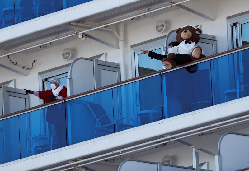 Passengers talk to each other on the balconies of their cabins on the cruise ship Diamond Princess, where dozens of passengers were tested positive for coronavirus, at Daikoku Pier Cruise Terminal in Yokohama, south of Tokyo, Japan, February 11, 2020. REUTERS/Issei Kato