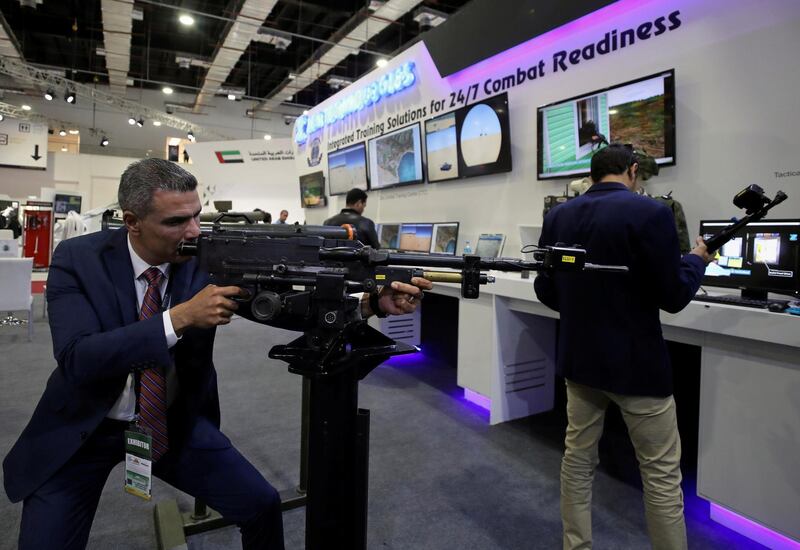 A visitor holds a weapon at the Indian stand during the first day of Egypt Defense Expo in Cairo. Reuters
