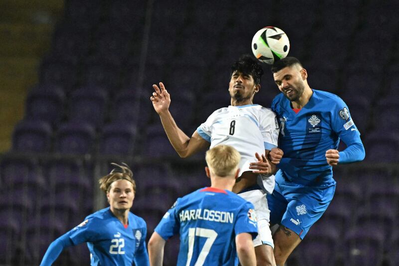 Iceland defender Victor Palsson and Israel midfielder Dor Peretz compete for a header. AFP