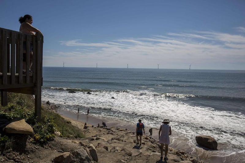 Tourists look out to sea and the GE-Alstom Block Island wind farm. Scott Eisen / Getty / AFP
