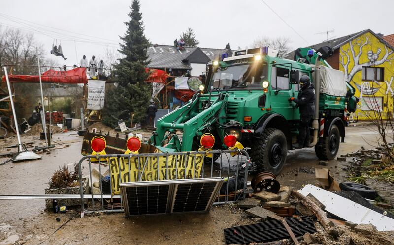 Barricades in the village are cleared by police. EPA