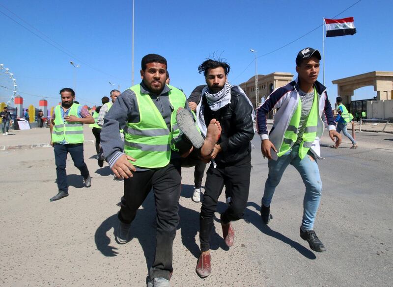Men carry away a wounded demonstrator away during a protest in front of the governorate building in Basra, Iraq. Reuters