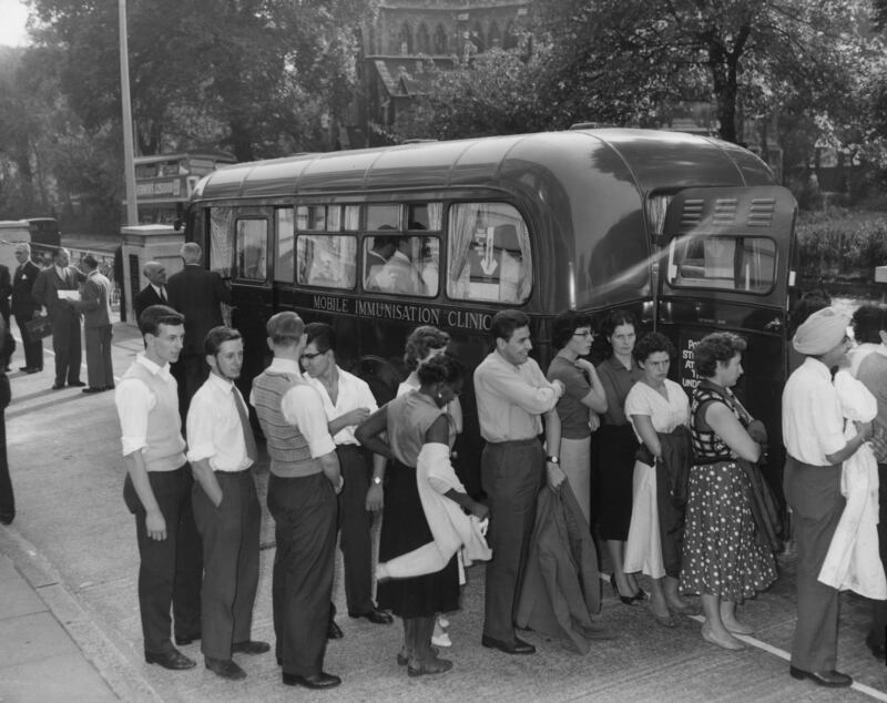 A queue of factory workers waiting to receive polio vaccinations in one of the new London Mobile Immunisation Clinics at Highbury Grove in 1959. 