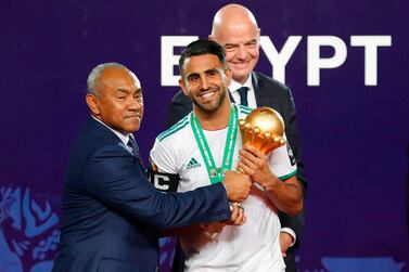Algeria's captain Riyad Mahrez, centre, with the Africa Cup of Nations trophy. AFP 