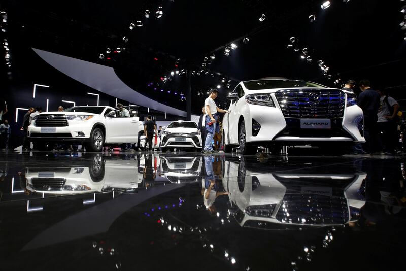 Visitors look at Toyota models at Auto Guangzhou event in China. Bobby Yip / Reuters