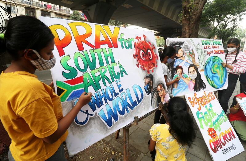 Pupils apply finishing touches to paintings made to boost awareness of the new coronavirus Omicron variant, in Mumbai. Reuters