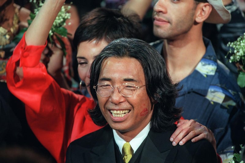 Fashion designer Kenzo Takada acknowledges the audience after showing his final Kenzo collection on October 7, 1999. AFP