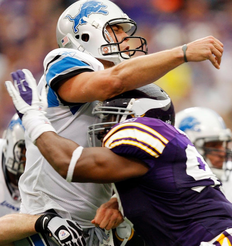 Detroit Lions quarterback Matthew Stafford (top) grimaces as he is hit by Minnesota Vikings defensive tackle Kevin Williams during the fourth quarter of their NFC football game in Minneapolis September 25, 2011. Detroit won the game in overtime.  REUTERS/Eric Miller (UNITED STATES - Tags: SPORT FOOTBALL) *** Local Caption ***  MIN14_NFL-_0925_11.JPG