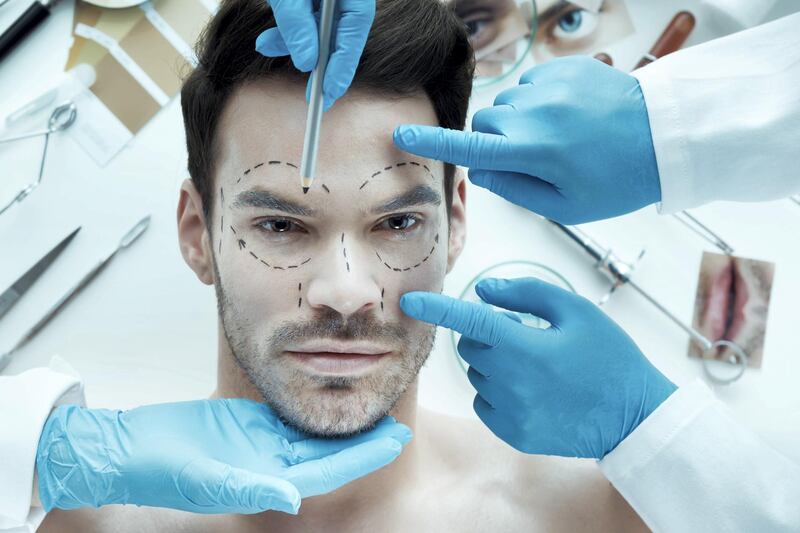 Handsome man at beautician. Plastic surgery concept.