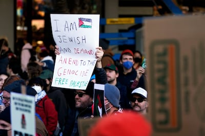 A Jewish demonstrator holds a sign in solidarity during a pro-Palestinian rally and march, on October  28, in Seattle, US. AP