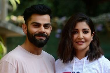 Indian cricketer Virat Kohli (L) with his wife Bollywood actress Anushka Sharma attends a promotional event in Mumbai on February 23, 2022.  (Photo by SUJIT JAISWAL  /  AFP)
