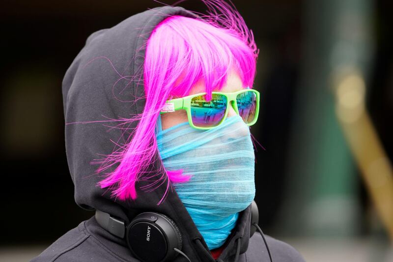 A person wears a scarf as a protective face mask in Melbourne after it became the first city in Australia to enforce mask-wearing in public as part of efforts to curb a resurgence of the coronavirus disease (COVID-19), July 23, 2020. REUTERS/Sandra Sanders