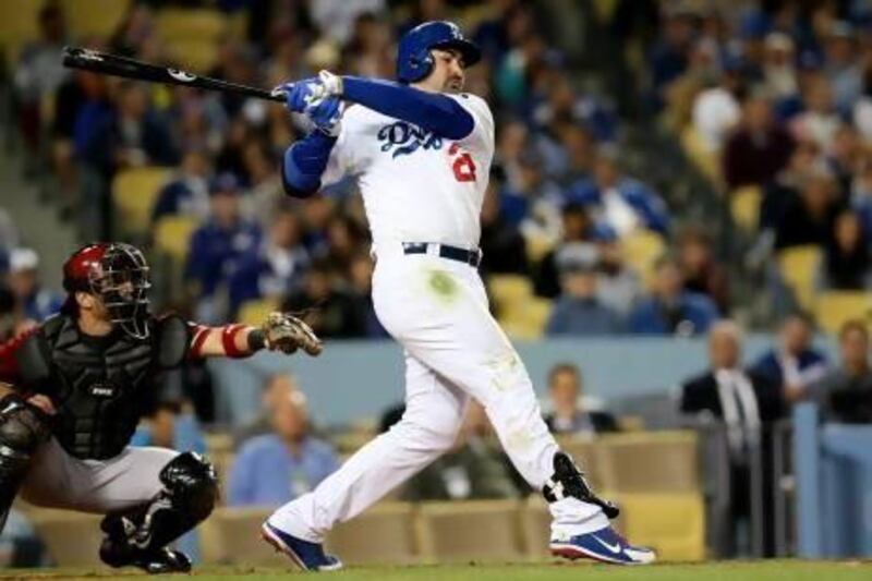 Adrian Gonzalez, right, came to LA via Boston last year and has led Dodgers into first place. Stephen Dunn / AFP