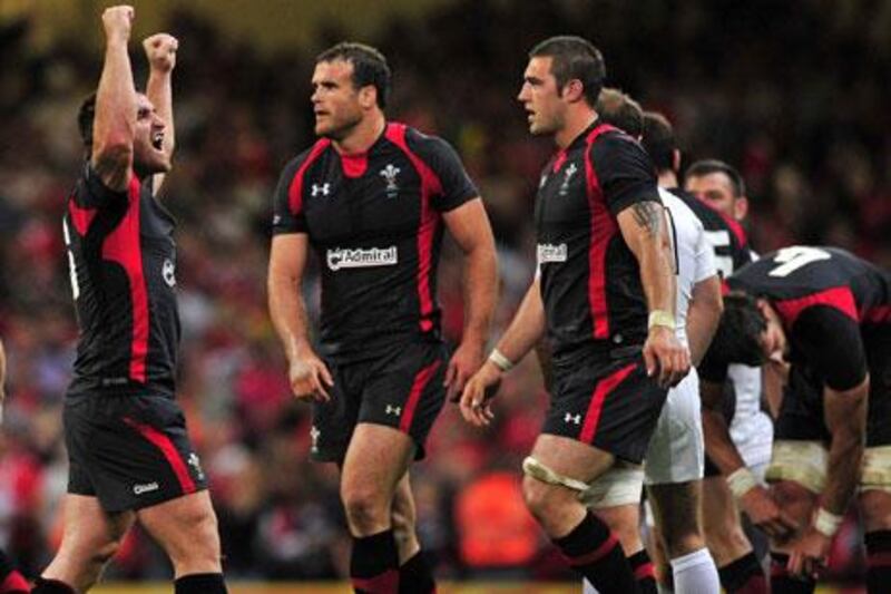 Huw Bennett, left, raises his arms in celebration of Wales' 19-9 victory over England in a warm-up to the Rugby World Cup at Cardiff.