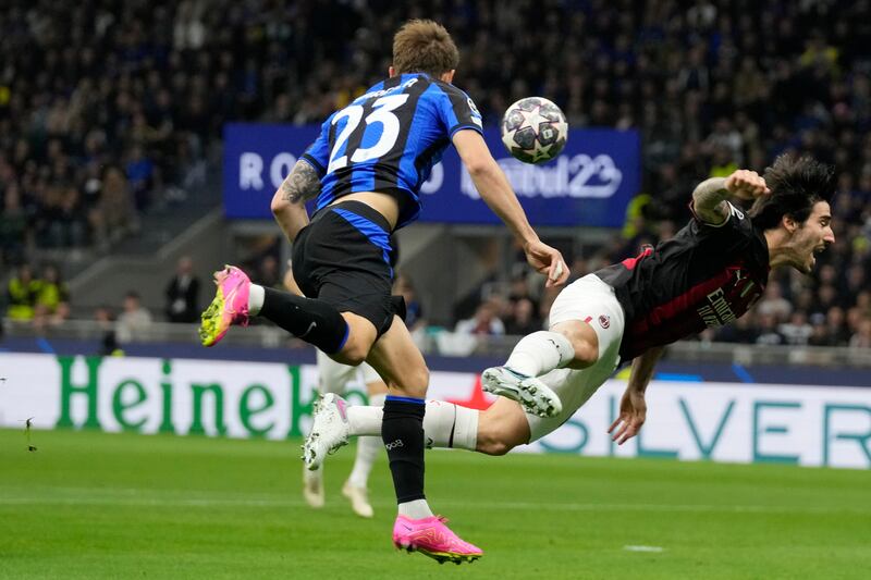 AC Milan's Sandro Tonali, right, is challenged by Inter's Nicolo Barella. AP 