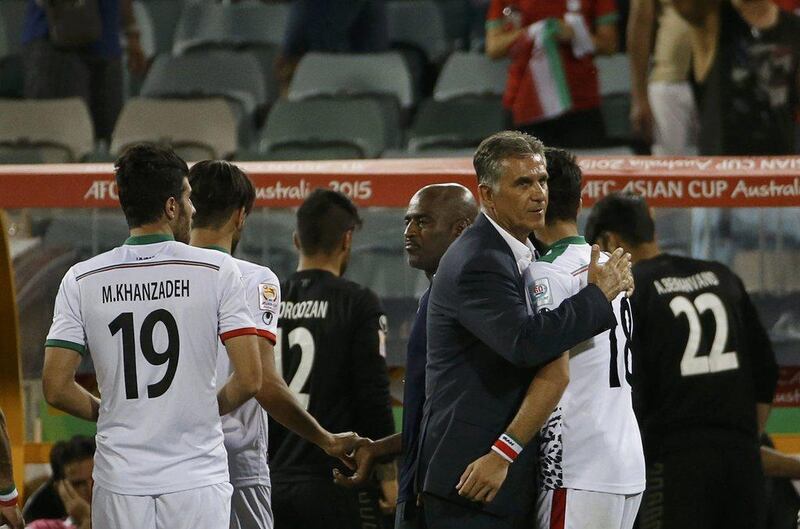 Iran coach Carlos Queiroz, centre, consoles players after their Asian Cup quarter-finals defeat to Iraq on Friday. Edgar Su / Reuters / January 23, 2015