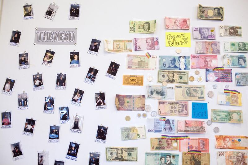 World currencies and photographs are displayed on a wall at the ConsenSys Inc. office in the Brooklyn borough of New York, U.S., on Thursday, March 29, 2018. The employees of ConsenSys, the blockchain startup co-created by Ethereum guru Joseph Lubin, have taken over the space at 49 Bogart Street in the Bushwick neighborhood of Brooklyn. Photographer: Holly Pickett/Bloomberg