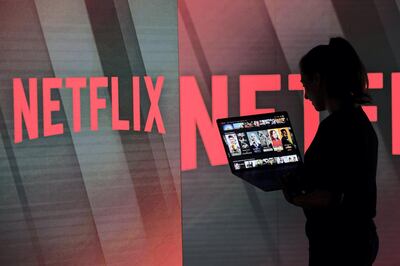 A woman browses the Netflix Inc. homepage on a laptop computer amongst illuminated screens bearing the company logo in this arranged photograph in London, U.K., on Tuesday, June 26, 2018. Addressing a room filled with New Delhi’s business elite earlier this year, Netflix Inc. Chief Executive Officer Reed Hastings offered a prediction: His company’s next 100 million customers will come from India. Photographer: Chris Ratcliffe/Bloomberg