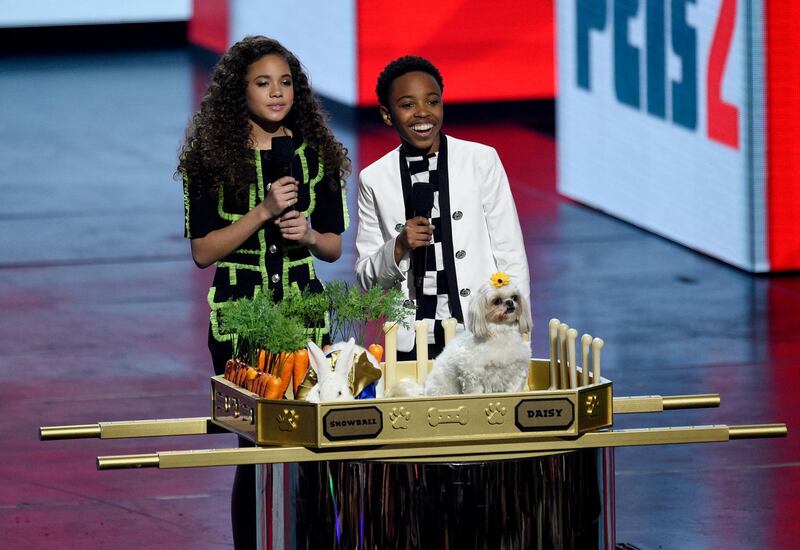 Scarlet Spencer, left, and Dallas Supree Young speak while a rabbit named Snowball and a Shih Tzu named Daisy appear on stage. AP