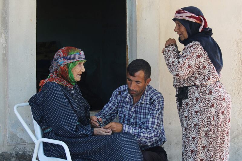 Here, Heimish listens to her daughter Khadijeh Shoueib as her grandson Abdo Nahar clips her nails.