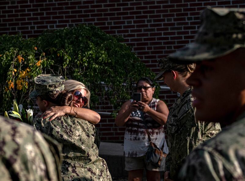 US Navy sailors give flowers to the sister of Max  Soviak during a vigil at Edison Middle School in Berlin Heights, Ohio. AFP