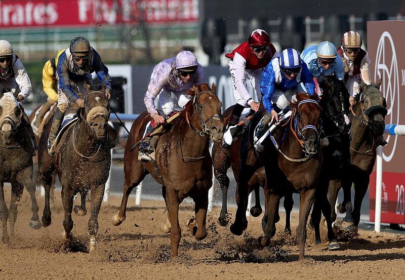 Jockey  Paul Hanagan riding Tamarkuz (third from right) wins the Godolphin Mile during the Dubai World Cup at the Meydan Racecourse in Dubai. ( Satish Kumar / The National )