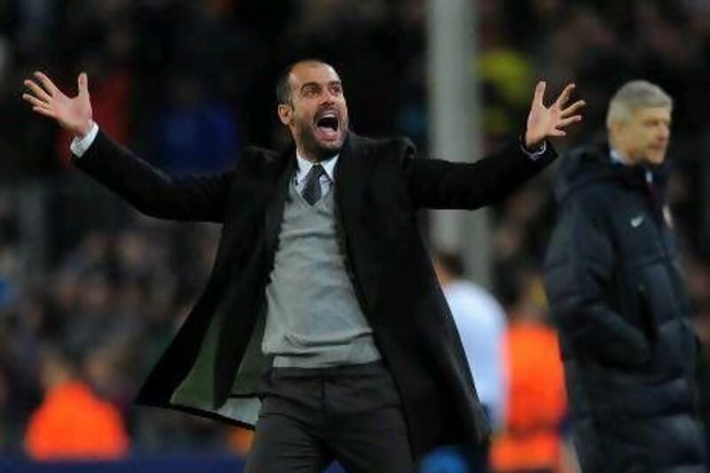 Barcelona's coach Pep Guardiola celebrates after his team scores a goal during their Champions League round of 16, 2nd leg football match FC Barcelona vs Arsenal on March 8, 2011 at Camp Nou stadium in Barcelona. AFP PHOTO / LLUIS GENE