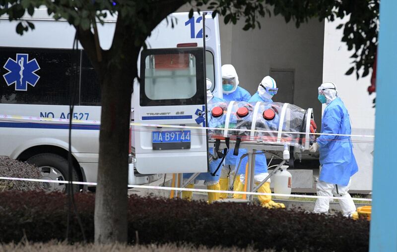 Medical workers in protective suits lift an isolated patient from an ambulance as the country is hit by an outbreak of the new coronavirus, in Chengdu, Sichuan province, China. Reuters