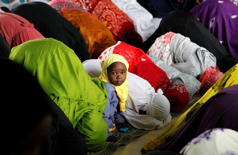 A child is seen among Muslim faithfuls attending the morning prayers of Eid al-Fitr at the California grounds in Nairobi, Kenya. Reuters