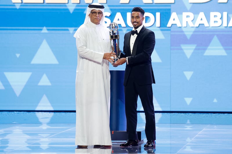 President of the Asian Football Confederation Sheikh Salman bin Ibrahim Al Khalifa presents Salem Al Dawsari with the AFC Player of the Year award. AFP