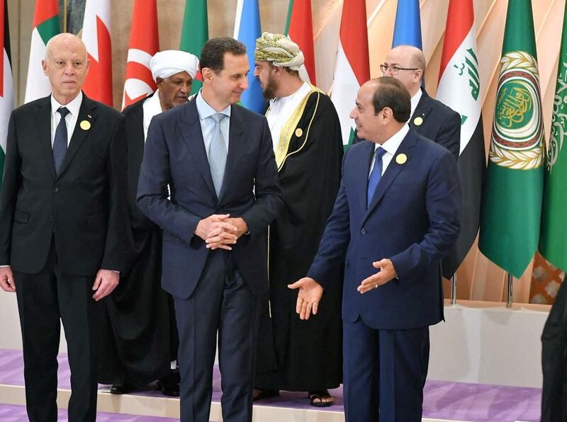 Syria's President Bashar Al Assad, centre, greets his Egyptian counterpart Abdel Fattah El Sisi, right, as Tunisia's President Kais Saied looks on, at the Arab League summit in Jeddah. AFP