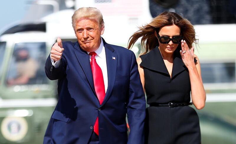 U.S. President Donald Trump gestures to reporters as he walks from Marine One with first lady Melania Trump to board Air Force One as they depart Washington on campaign travel to Nashville, Tennessee to attend his second and final debate with Democratic presidential nominee Joe Biden, at Joint Base Andrews, Maryland, U.S., October 22, 2020. REUTERS/Tom Brenner