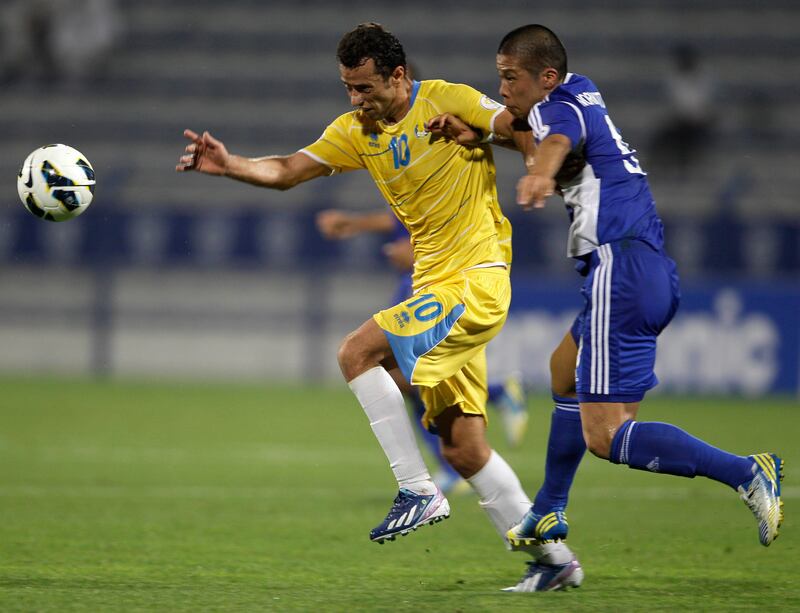 Anderson Luis De Carvalho from Al Gharafa of Qatar, left, fights for the ball with Morimoto Takayuki from Al Nasr of the UAE during an AFC Champions League match  in Dubai, United Arab Emirates, Tuesday, April 2, 2013. (AP Photo/Kamran Jebreili) *** Local Caption ***  Mideast Emirates Soccer AFC Champions League.JPEG-008dd.jpg