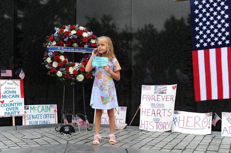 Eliana Duy, 8, FL, stands in front of the wreath that US Secretary of Defense James Mattis, General John Kelly, White House Chief of Staff and Cindy McCain, wife of late Senator John McCain, lay a ceremonial wreath honouring all whose lives were lost during the Vietnam War. Reuters