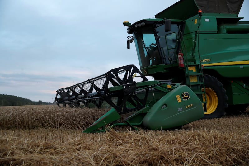A John Deere combine harvester is seen harvesting winter wheat in a field near Kimpton, Britain, August 5, 2020. Picture taken August 5, 2020.  REUTERS/Peter Cziborra
