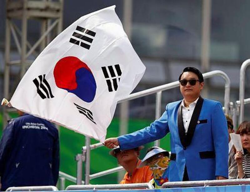 A man waves a South Korean flag during the Twenty20 competition in the Asian Games. REUTERS/Issei Kato