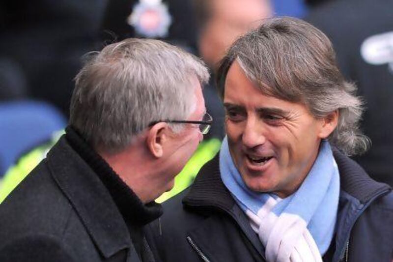 Roberto Mancini, right, the Manchester City manager, praised Sir Alex Ferguson, left, for the mentality at Manchester United, but says his side will be better than their city and title rivals. Paul Ellis / AFP