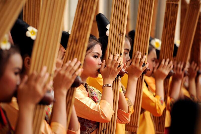 Performers rehearse using a Khean instrument during the 28th Association of Southeast Asian Nations (ASEAN) Summit at the National Convention Centre (NCC) in Vientiane. AFP