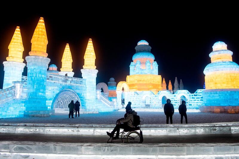 A tourist sits on an ice bike at the Harbin Ice and Snow World festival in Harbin, in China's northeast Heilongjiang province.  AFP